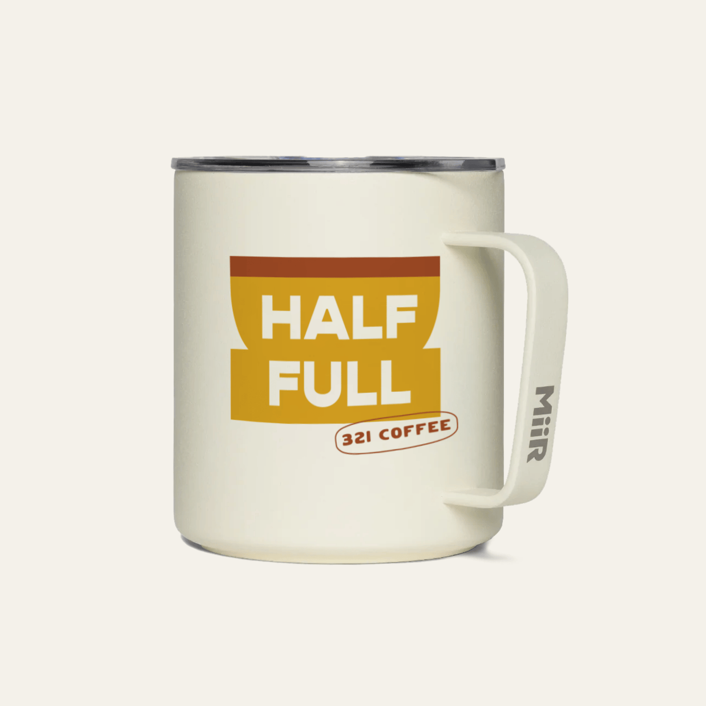 A light beige metal camp mug with "Half Full" printed in white on a yellow coffee mug.