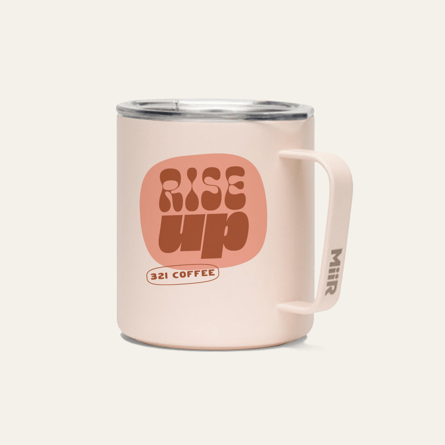 A light pink metal camp mug with "Rise Up" printed in red on the mug.