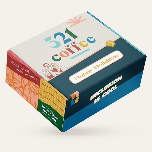 A gift box with colorful sketches of 321 Coffee baristas, "321 Coffee" written on the top, and "Happy Holidays" written on the bottom of the box.