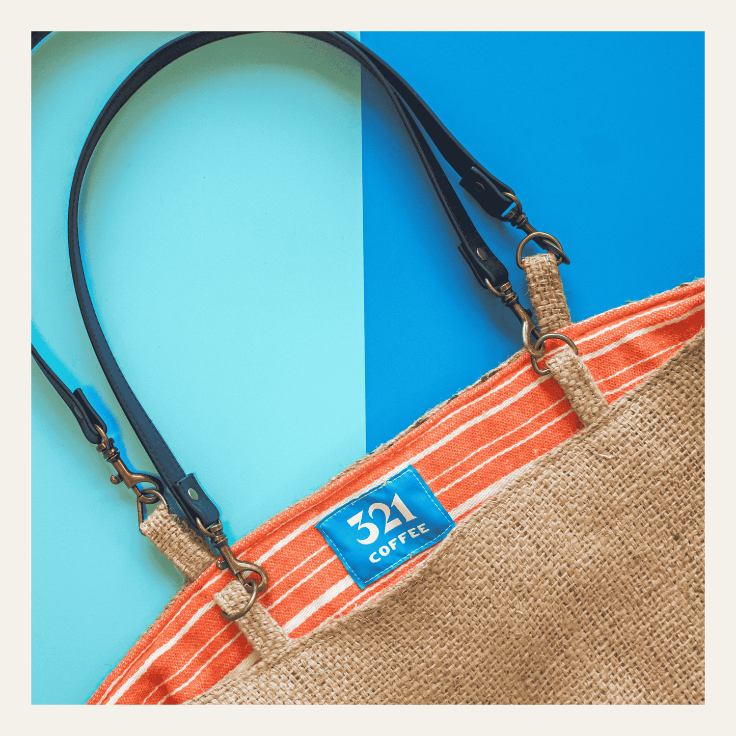 A single tote bag made from coffee burlap is shown on a blue and light blue background.