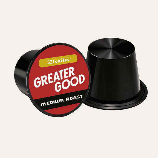 Coffee pod with the coffee name "Greater Good" on a red background of a black pod.