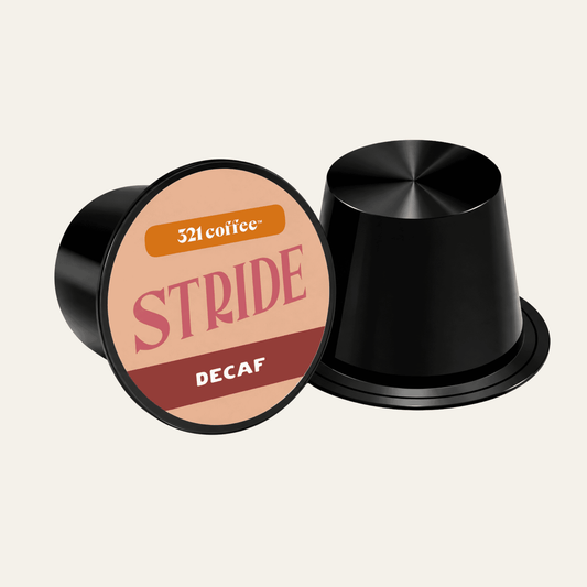 Coffee pod with the coffee name "Stride" on a pink background of a black pod.