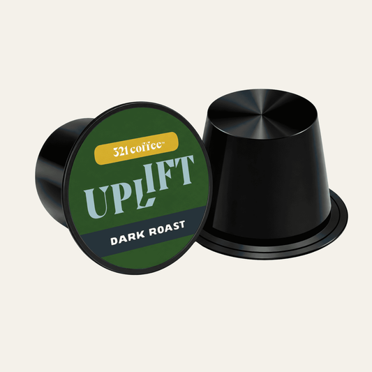 Coffee pod with the coffee name "Uplift" on a green background of a black pod.