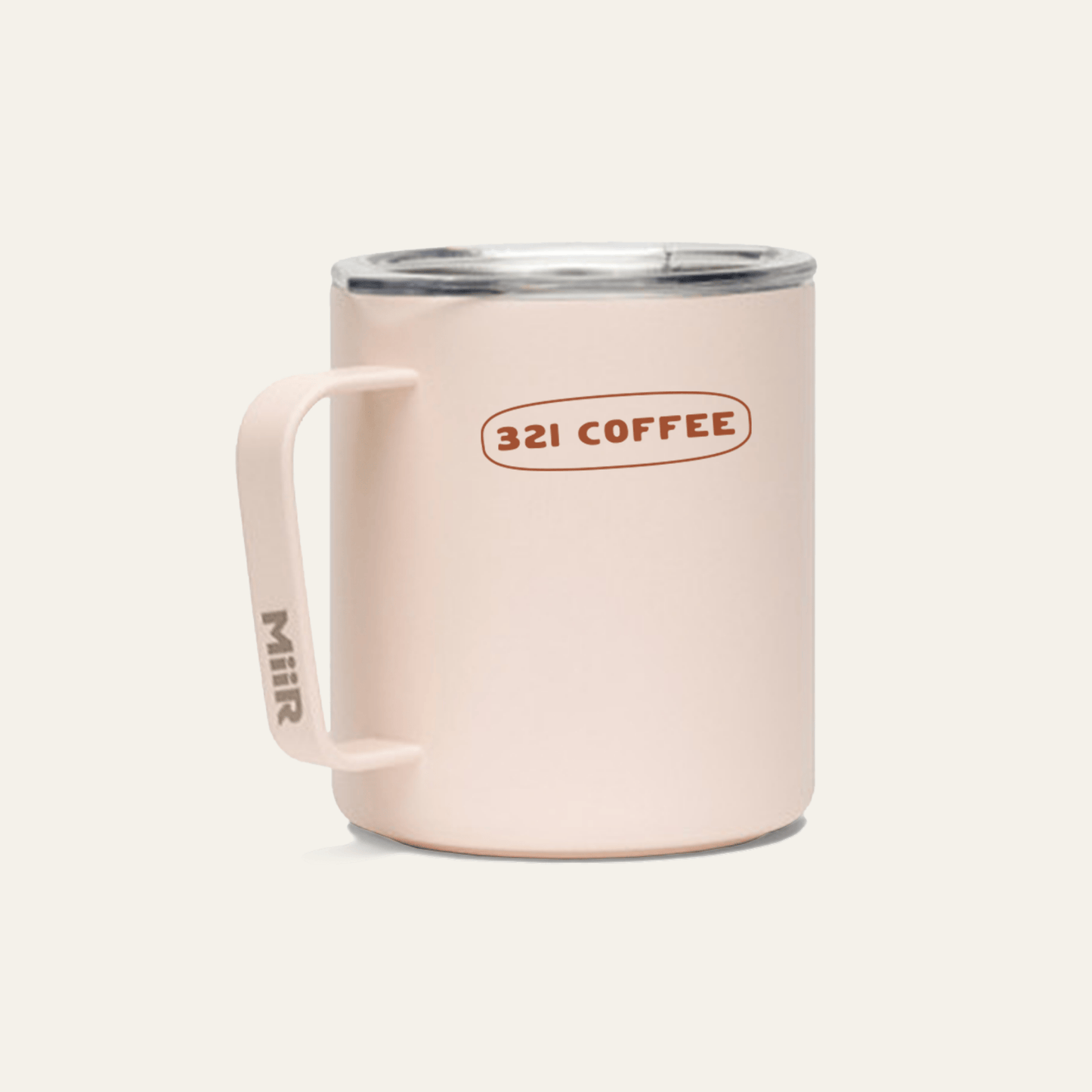 The back of a light pink metal camp mug with "321 Coffee" printed in red on the mug.