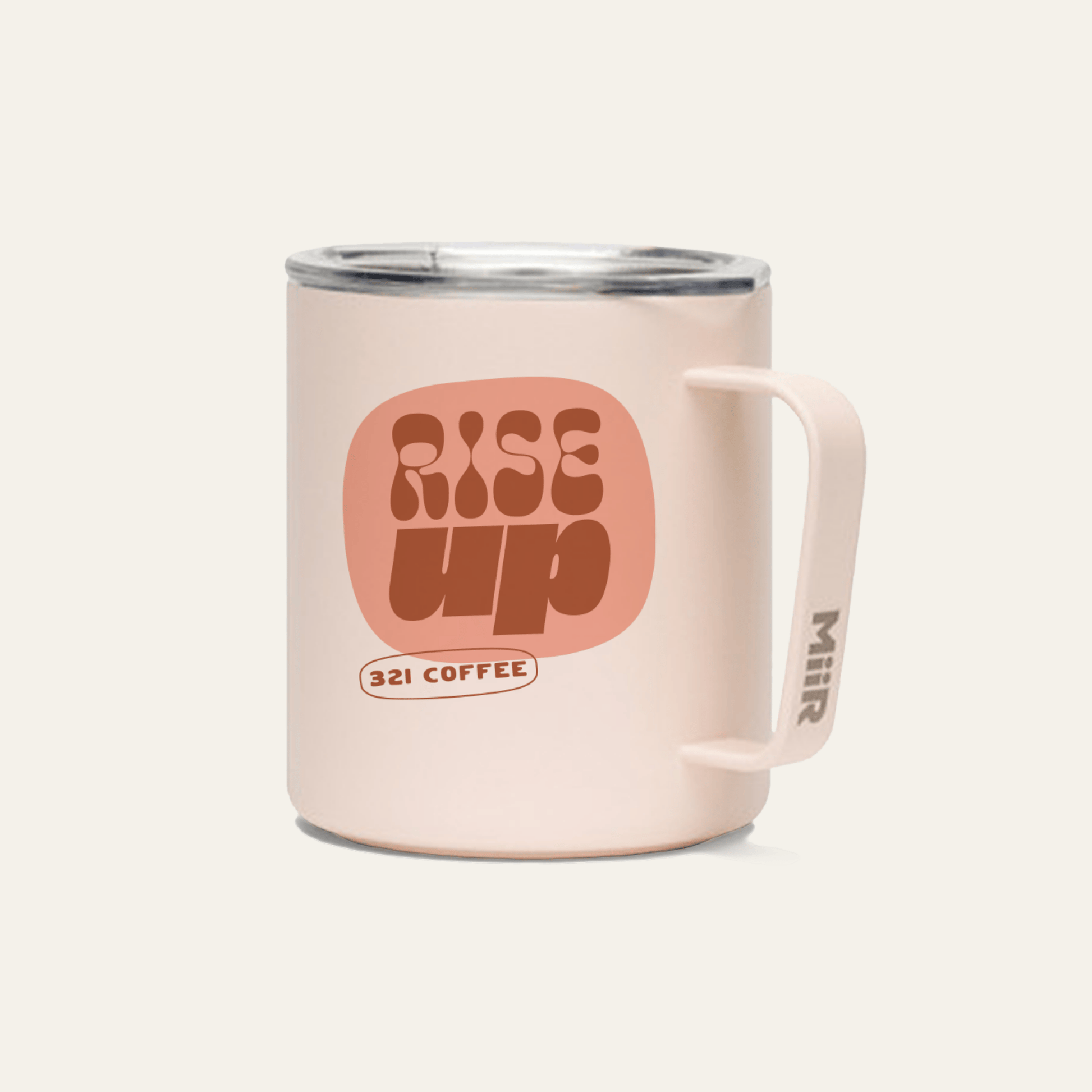 A light pink metal camp mug with "Rise Up" printed in red on the mug.