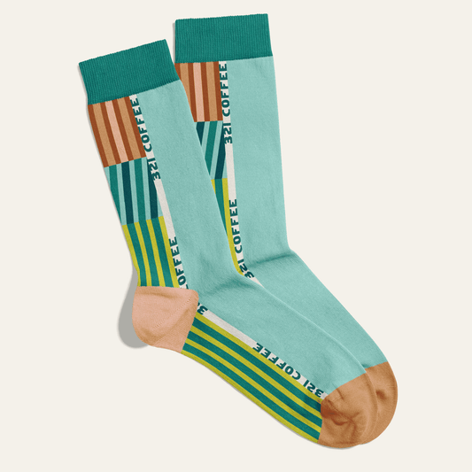 Graphic showing a pair of socks with "321 Coffee" written on it and colorful graphics inspired by DNA mapping.
