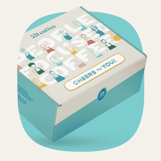 A gift box with colorful sketches of 321 Coffee baristas, "321 Coffee" written on the top, and "Cheers to You" written on the bottom of the box.