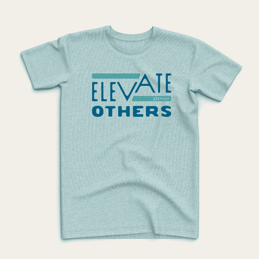 Teal t-shirt reading "Elevate Others" in blue text on the front.