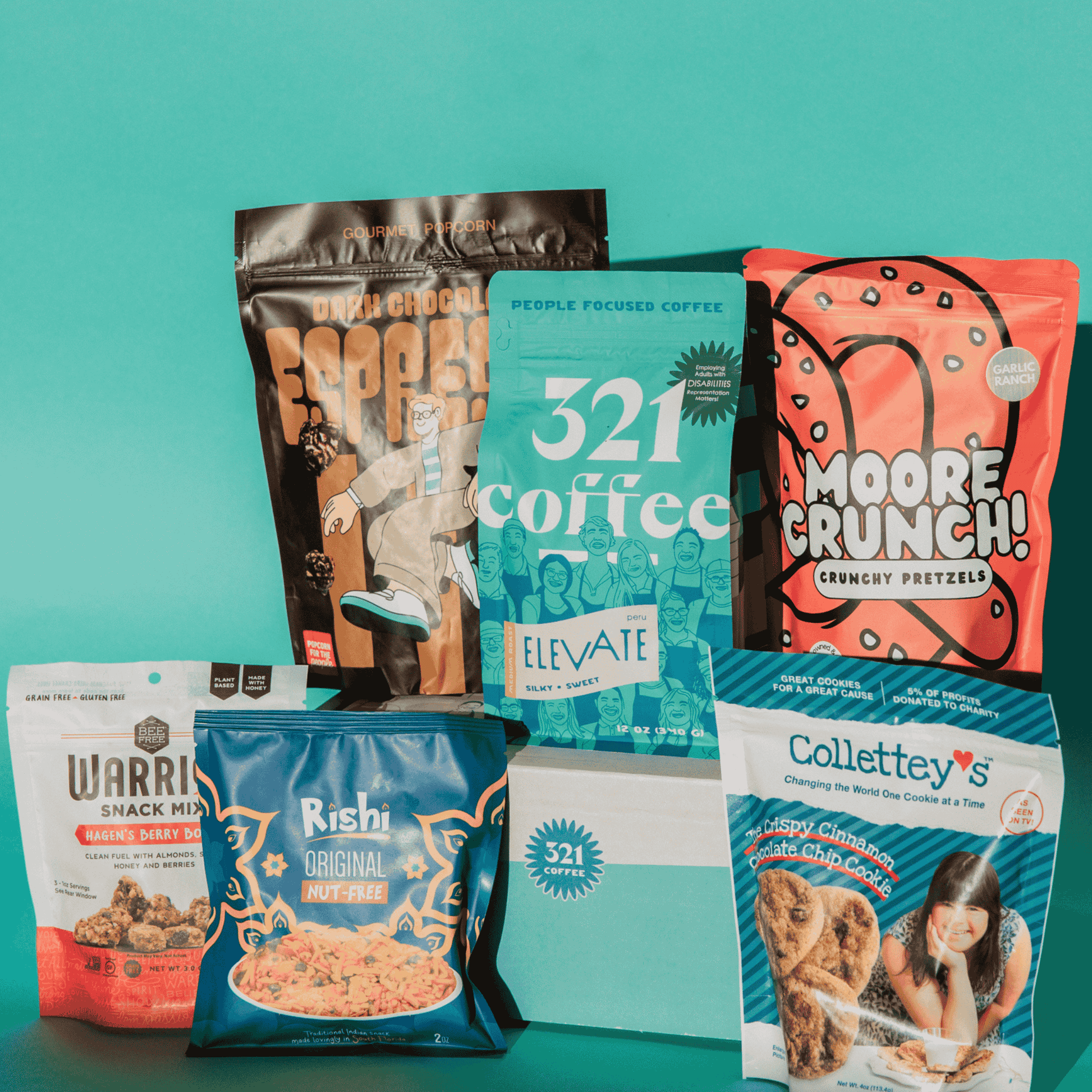 Collection of snack and coffee packages on a teal background