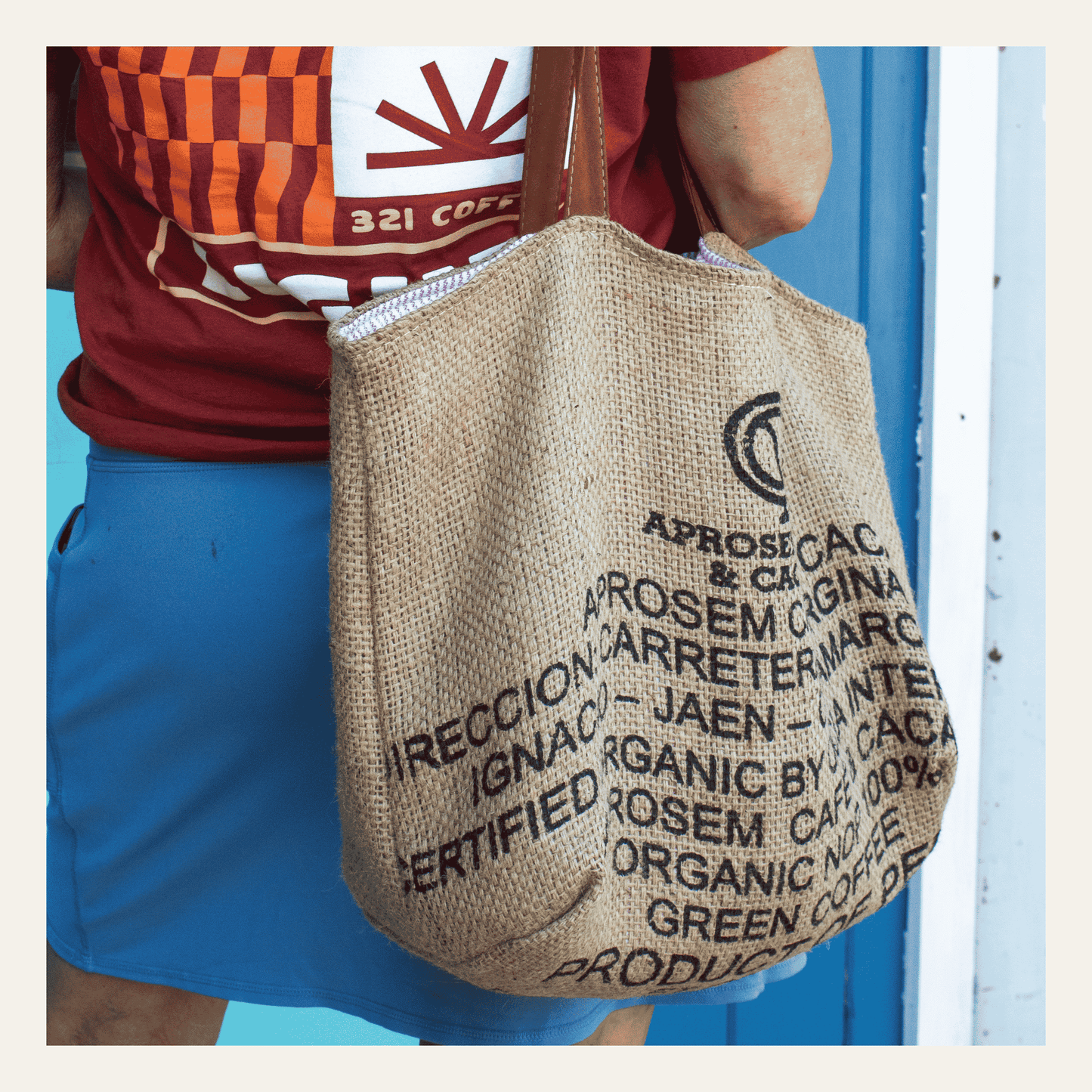 A single tote bag made from coffee burlap is shown over the shoulder of a user.