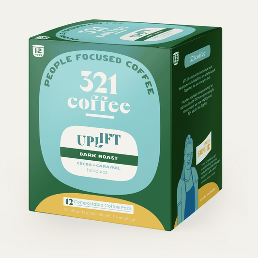 A 3D box of 321 Coffee's Uplift coffee pods. The box is green with elements of 321 Coffee's branding.